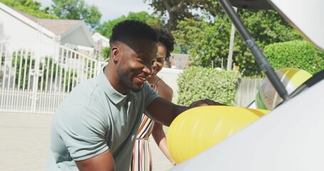 Happy african american family packing car with beach items on holiday © WavebreakMediaMicro