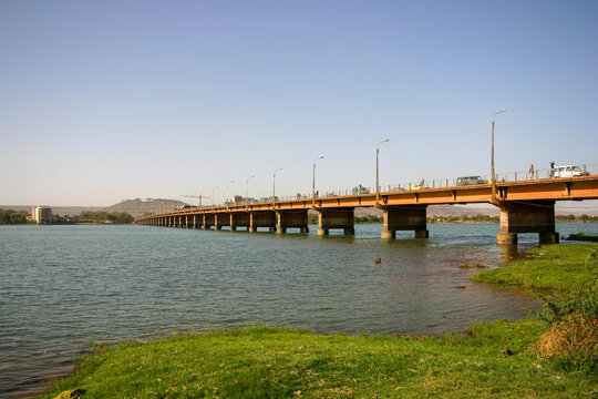 Long concrete bridge with street lights spanning the Niger River from a grassy bank, Bamako District, Bamako, Mali