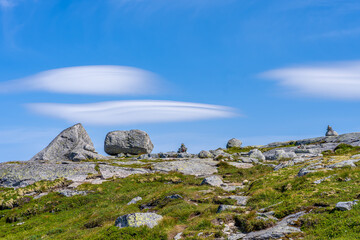 Lenticular clouds over boulders and cairns on Kjerag plateau, Norway © FelixB