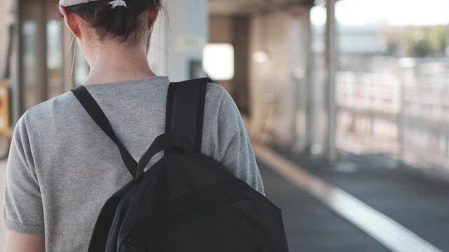 Rear View of Woman Walking on Train Station Platform in Slow Motion