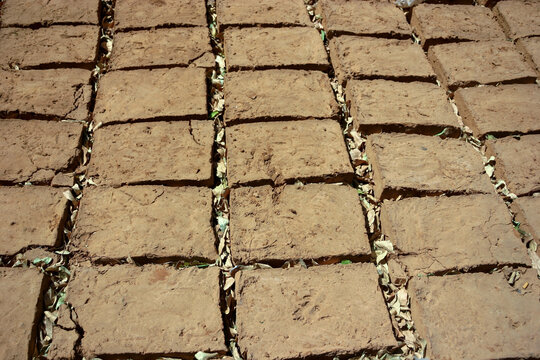 Rows of handmade adobe mud bricks drying in the sun, Segou Region, Segou, Mali