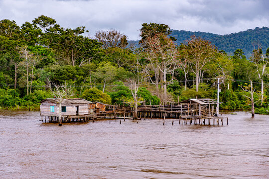 Wooden stilt house and rustic pier on the banks of the Amazon River near Almeirim, Para, Brazil