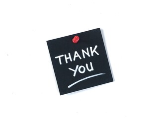 Black adhesive note with handwritten thank you message attached with a red push pin on a white background. Perfect for appreciation, business, and greeting concepts © Eka