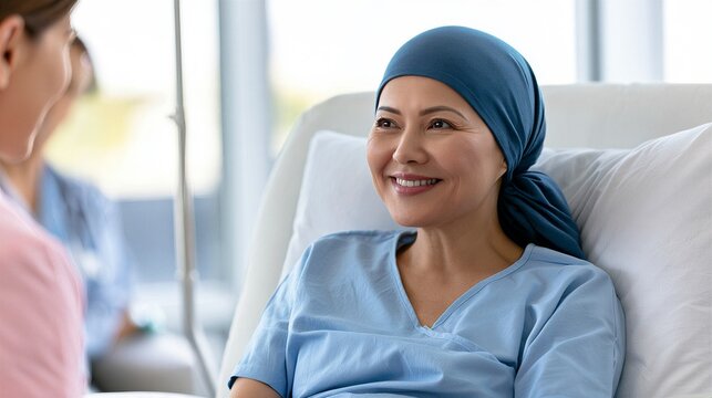 Smiling woman in headscarf sitting in hospital bed and talking with visitor. Patient recovery and supportive care. Healthcare, cancer treatment and resilience. Hospital consultation.