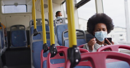 African american man and woman with face masks sitting in bus © WavebreakMediaMicro