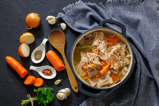 Rich pork rib bone broth in a black pot