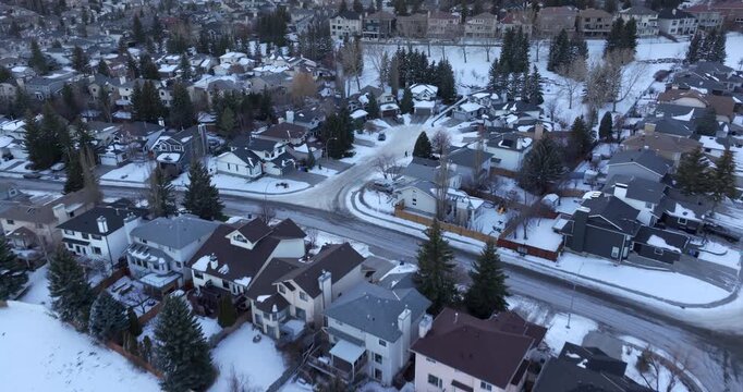 Aerial view of a residential neighborhood blanketed in snow on a winter day in Calgary, Alberta, Canada.	