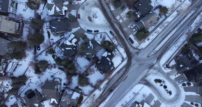 Top-down aerial view of a residential neighborhood blanketed in snow on a winter day in Calgary, Alberta, Canada.	