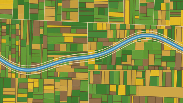 Aerial patchwork of green and golden farm fields divided by a wide meandering blue canal with parallel embankment tracks