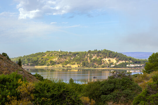 Early morning sunlight shing on the hilly shores of the pond of Peyriac de Mer, Aude, France