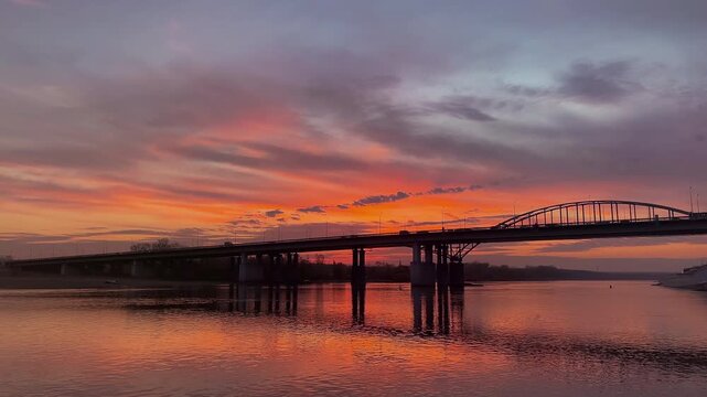 The river bridge bathed in the light of a magnificent sunset &mdash; stunning pink and golden hues