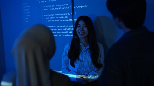Asian female IT instructor presenting programming code on screens, Smiling tech speaker teaching software development to students, Coding education and corporate technology training seminar concepts