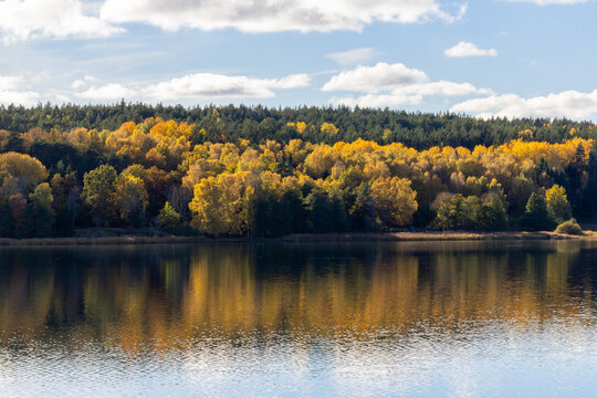 Nykoping, Sweden An autumn foliage landscape and reflections over an inlet in the Baltic Sea.