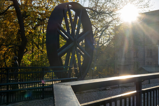 Nykoping, Sweden A large blue wheel iron industrial  sculture near the Storhusfallet waterfall in the downtown.