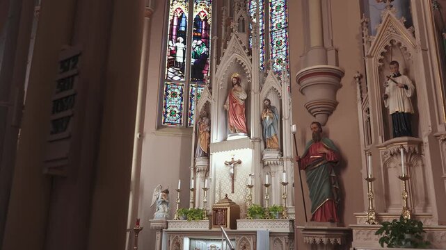 Ornate Catholic Church Altar with Sacred Heart of Jesus Statue, Saints, and Stained Glass Windows
