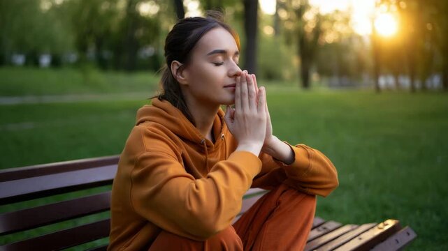 Breathing exercise with a woman holding palms together, outdoor meditation, nervous system regulation practice, everyday stress management