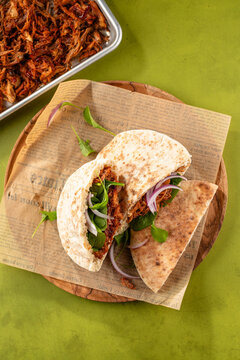 Pulled pork pita on wooden board
