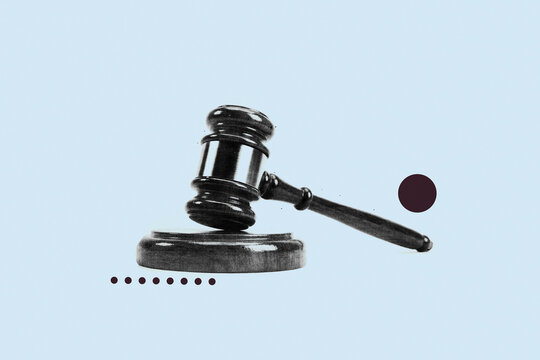 Wooden judge gavel and sound block on light blue background