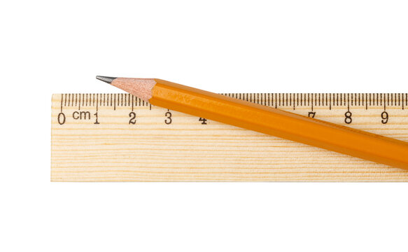 Yellow pencil resting across a wooden centimeter ruler
