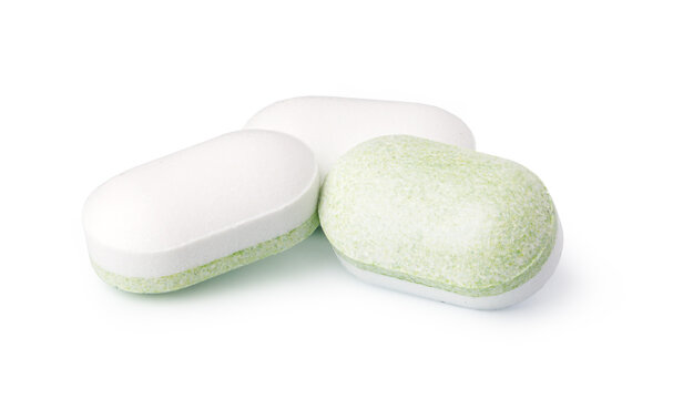 Green and white tablets isolated on a white background