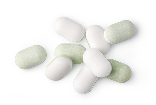 White and pale green medicine tablets isolated on a white background