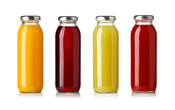 Colorful fruit juice in four sealed glass bottles isolated on white