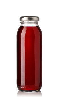 Glass bottle filled with red beverage on white background