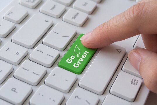 Go green button on white keyboard, eco friendly choice, sustainability