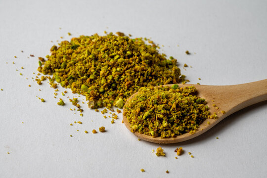 Ground Pistachios on Wooden Spoon