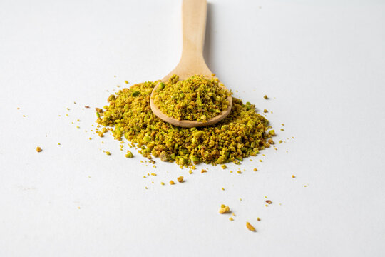 Ground Pistachios on Wooden Spoon