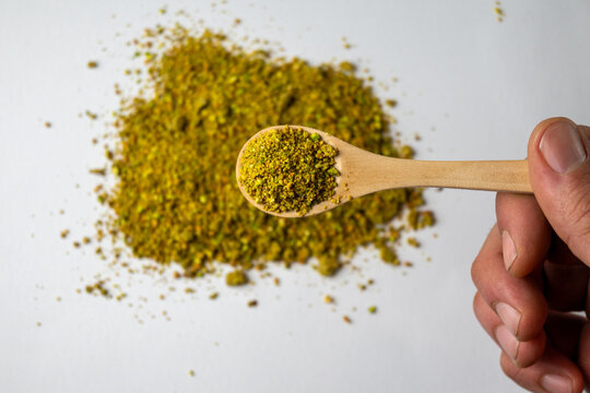 Ground Pistachios on Wooden Spoon