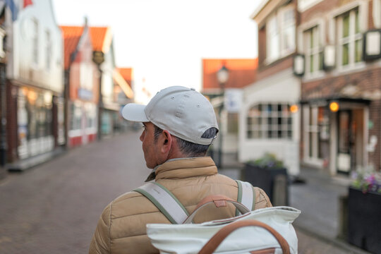 A traveler walking along an empty street in Volendam, Netherlands