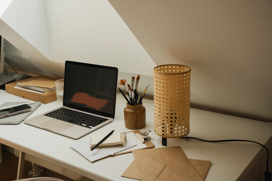 Cozy Scandinavian home office interior with laptop and natural decor