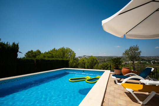 Poolside terrace overlooking hillside in Moraira