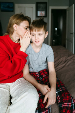 Whispers of Joy Between a Mother and Her Son in a Cozy Setting