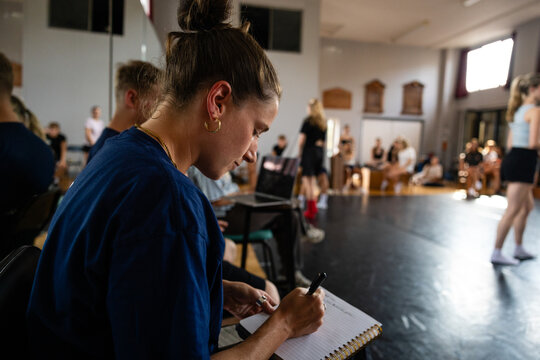 Taking notes as students rehearse