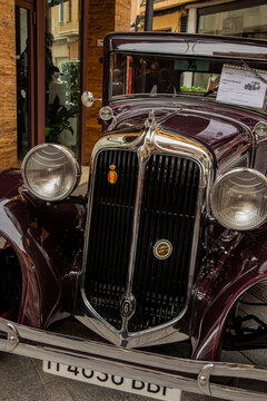 GANDIA, SPAIN - OCTOBER 4, 2026: Front view of a vintage 1931 Chrysler CM6 sedan featuring a chrome grille with 6 emblem, classic headlights, and polished dark maroon bodywork.