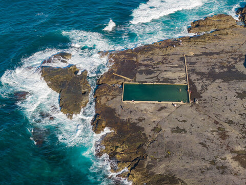 Ocean bath swimming pool on a large rock ledge at low tide
