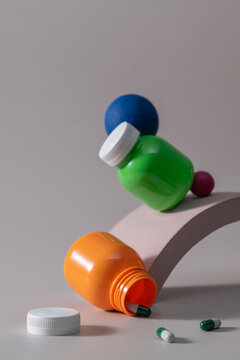Colorful medicine bottles and pills arranged in a precarious