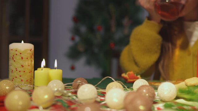Warm lifestyle footage shows two women who spend time together among cookies, candles and festive decorations. Wide table view conveys cozy home celebration in a polished lifestyle scene.