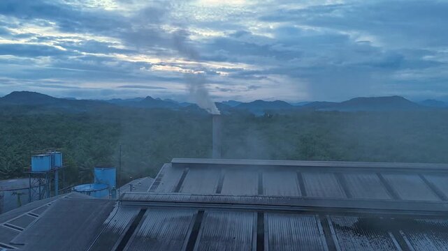Exhaust stack pipe releasing emissions dust reduces into environment. Aerial view shot monitoring and measurement of air pollution reduction to environmental, sustainability. Global warming, El Ni&ntilde;o.