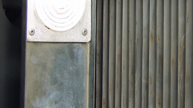 Close View of Dark Metal Fins and a Framed Industrial Panel. Close industrial footage emphasizes repeating metal fins, grids, pipes and structural frame details without claiming a specific function.
