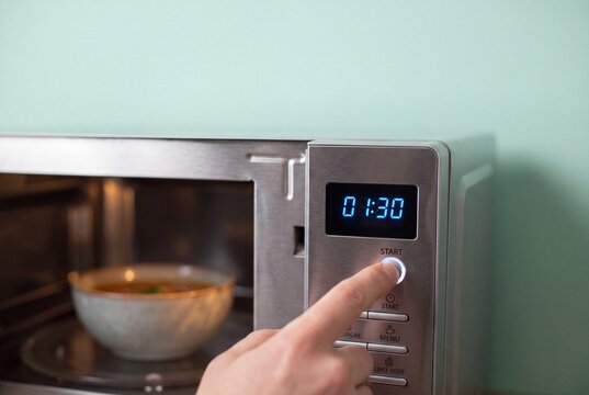 Setting a microwave timer in a home kitchen