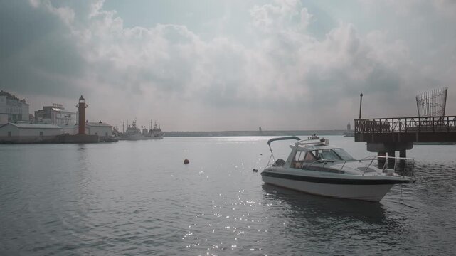 Speedboat Moored at Calm Harbor with Red Lighthouse in Gijang, Busan, South Korea