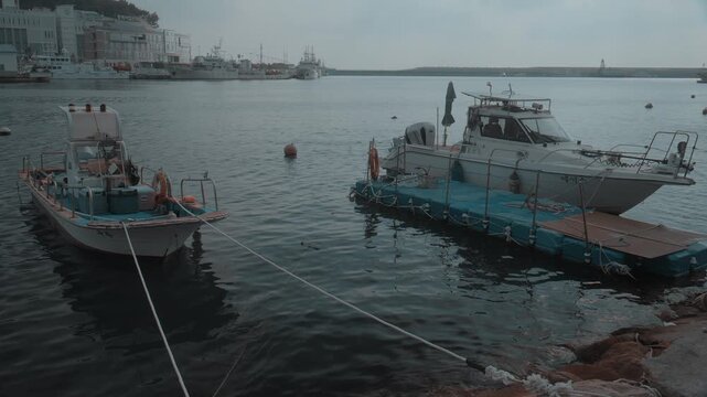 Boats Moored Along Stone Pier at Quiet Harbor in Gijang, Busan, South Korea