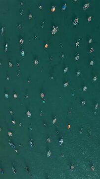traditional thung chai fishing boats and round basket coracles in turquoise clear sea water, creative gems and diamonds abstract pattern, Da Nang Vietnam, aerial drone view, vertical video 4k