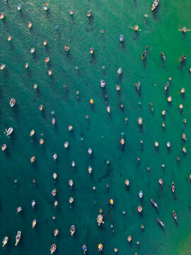 traditional thung chai fishing boats and round basket coracles scattered in turquoise clear sea water, creative gems and diamonds abstract pattern, Da Nang Vietnam, aerial top down drone view