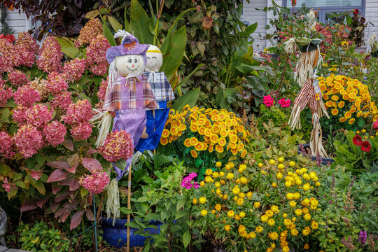 Colorful Autumn Garden Decorated with Playful Scarecrows and Seasonal Flowers