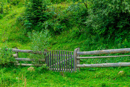 Old wooden fence with small gate