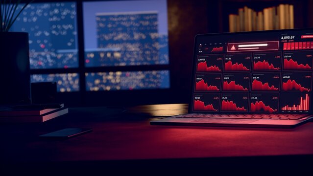 Open laptop is displaying red market charts in flat design on wooden desk, notebook nearby